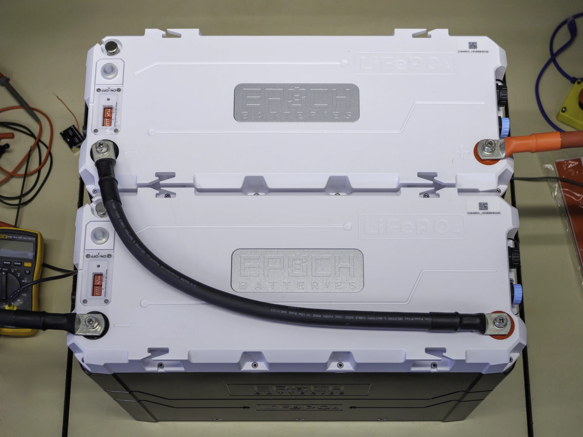 Photo of two Epoch 460Ah 12V batteries connected in series with  4/0 AWG cables forming a 24V 460Ah Batter bank